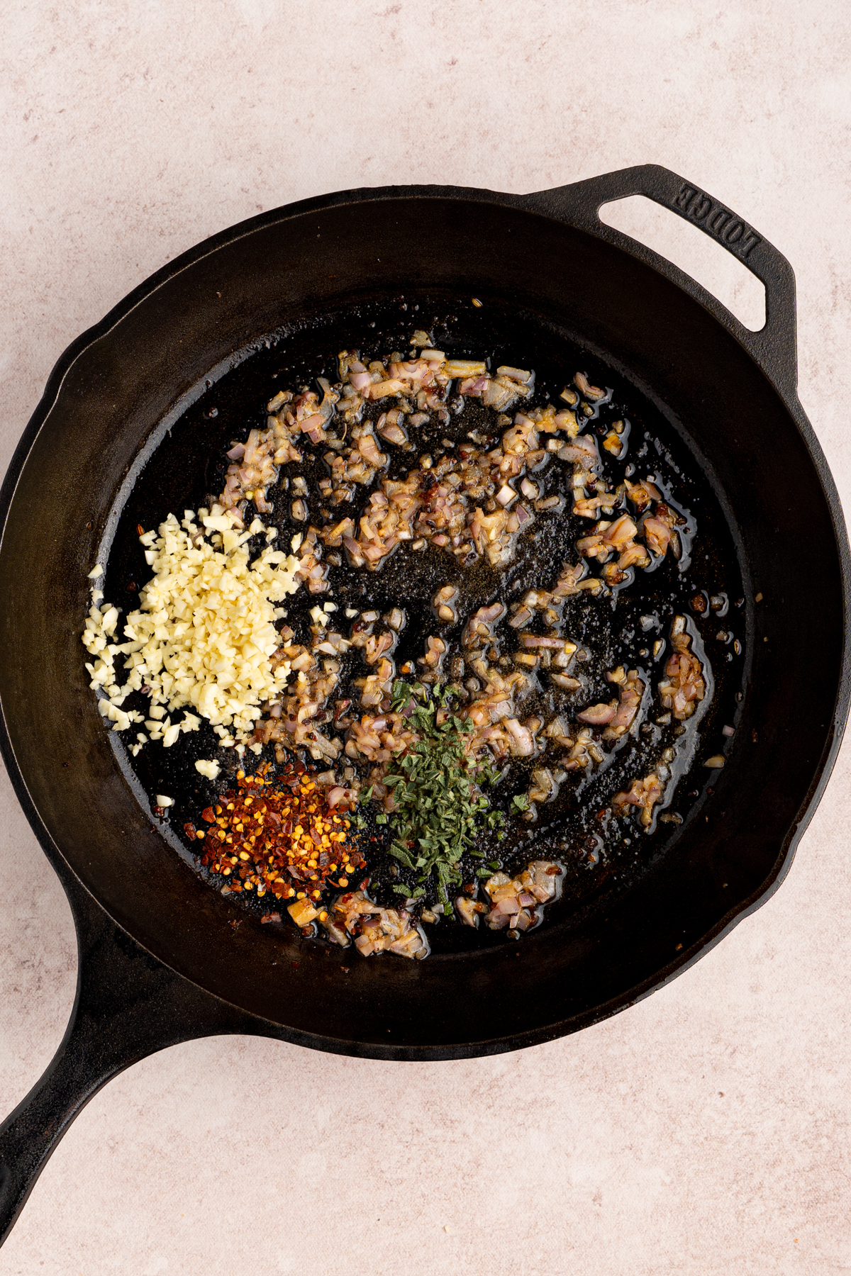 The aromatics cooking in the cast iron skillet.