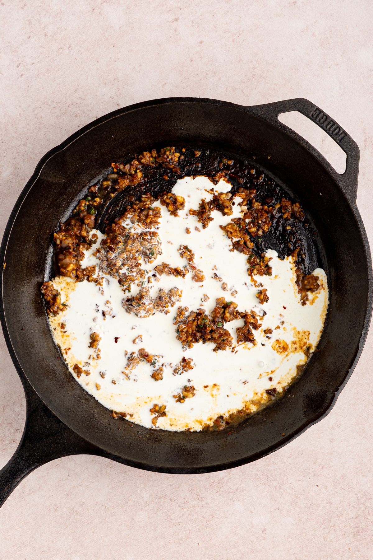 The cream in the pan before stirring.