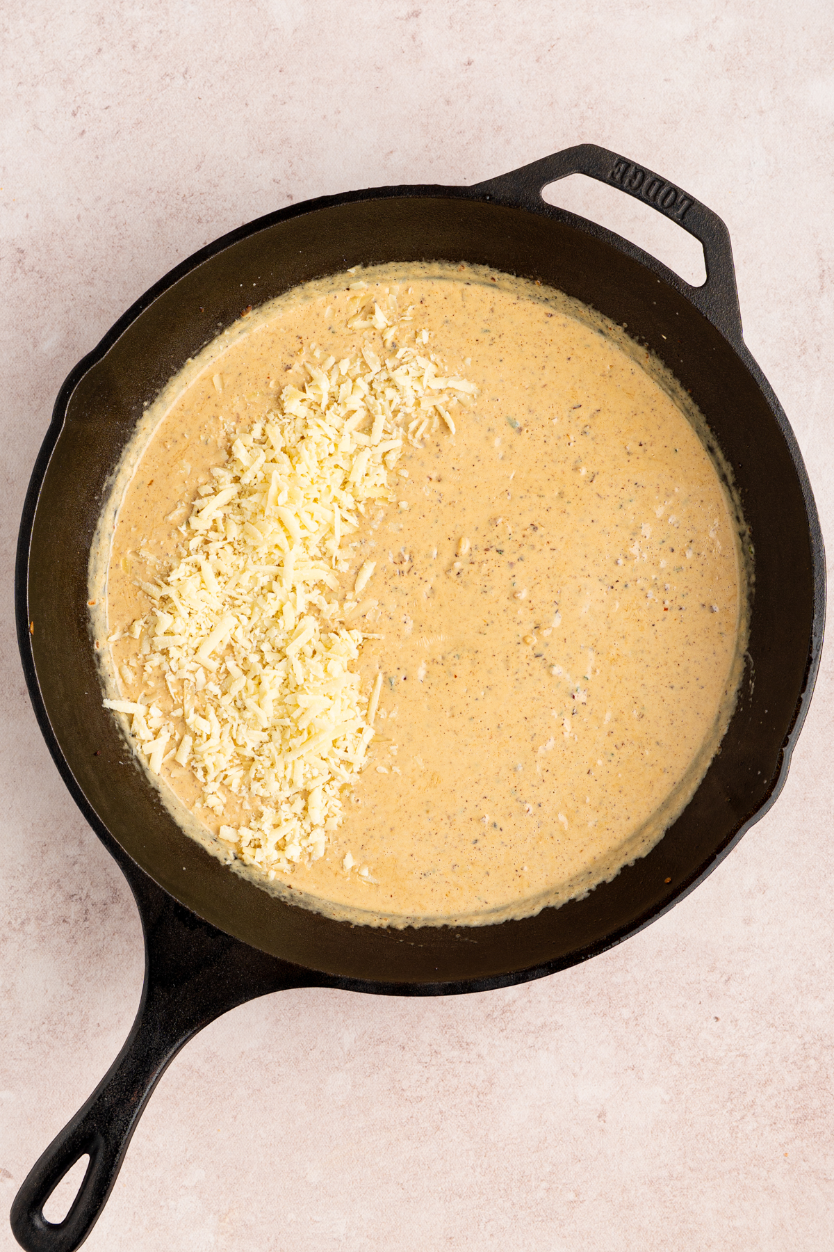 The parmesan cheese in the sauce before stiring.