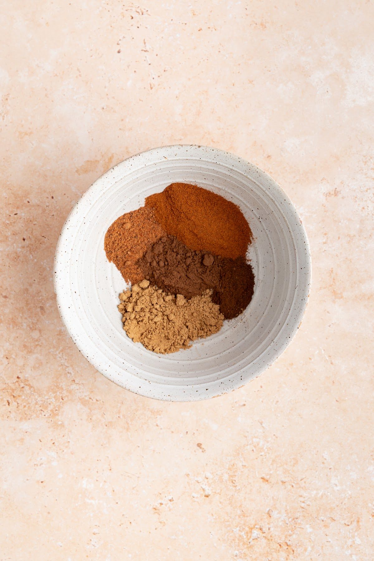 Ground cinnamon, ginger, allspice, nutmeg and cloves stirred together in a small bowl