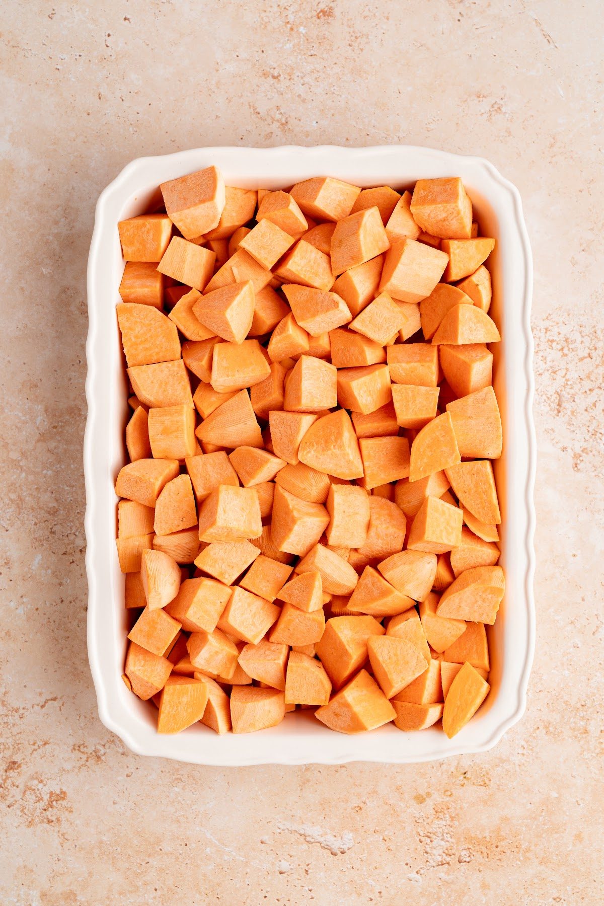 Peeled yams cut into medium half-moon pieces and spread in a buttered 13 by 9 inch baking dish